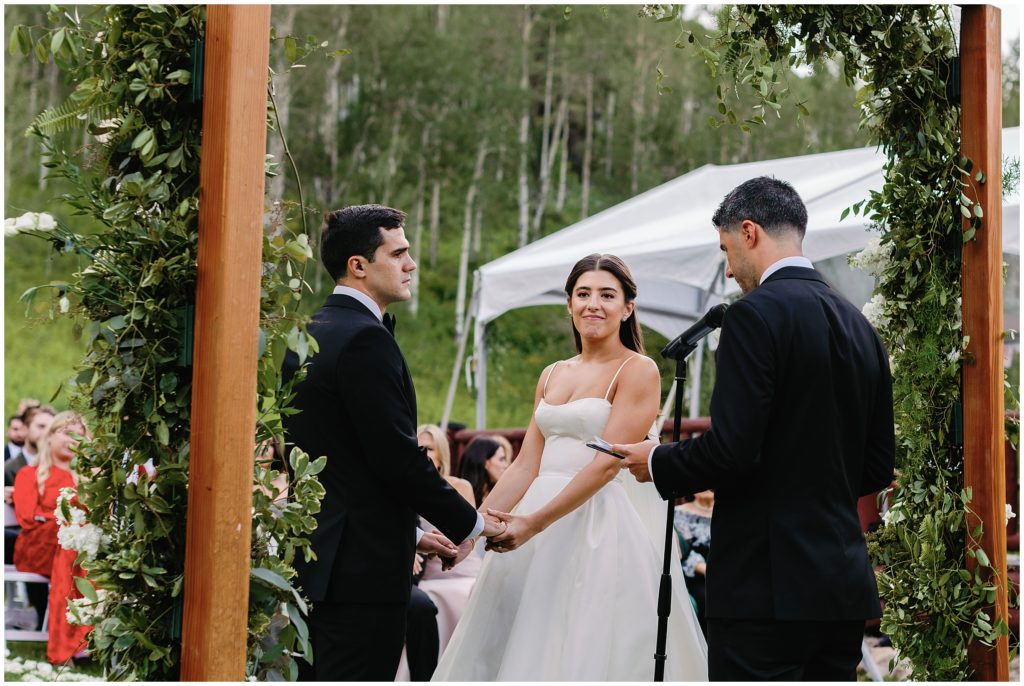 Groom and bride listening to officiant at Beano's Cabin