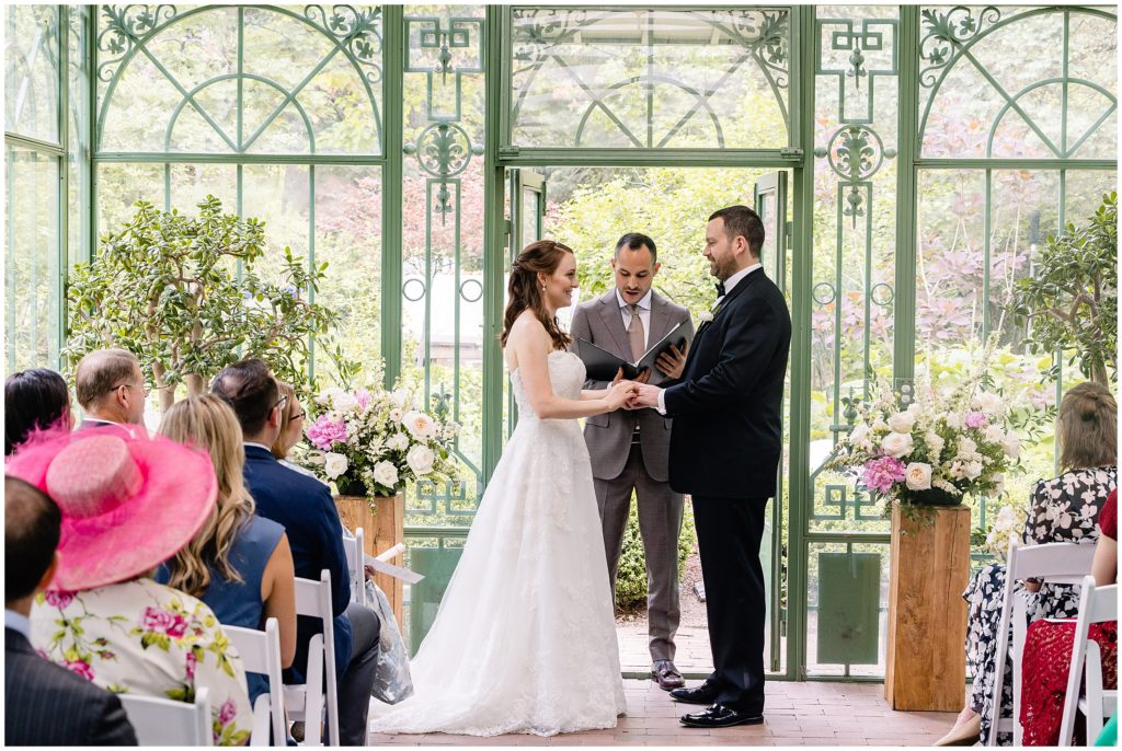 bride and groom listening to officiant at denver botanic gardens