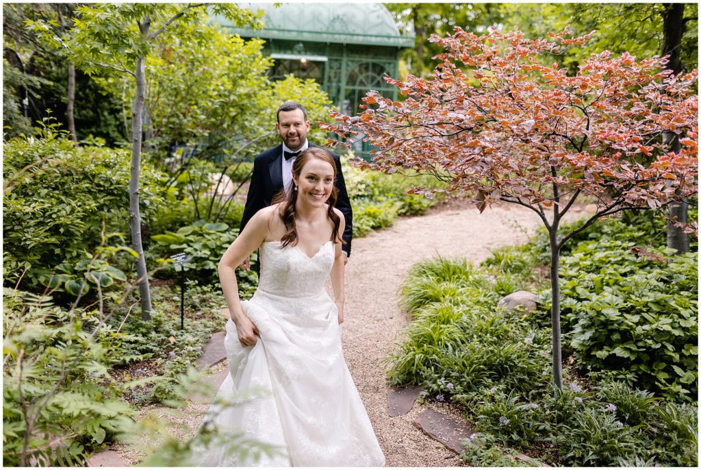 bride and groom walking on trail at denver botanic gardens