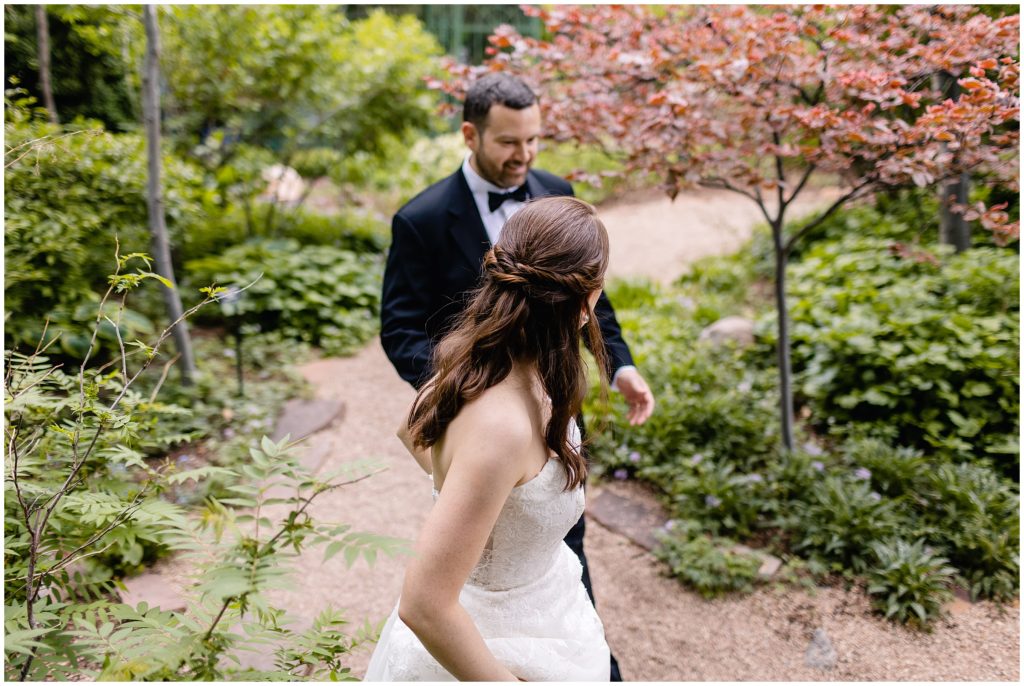 bride and groom walking on trail at denver botanic gardens