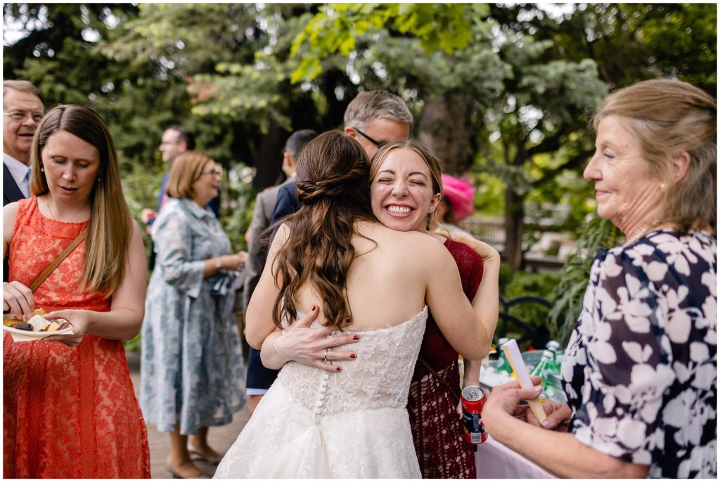 Bride greeting guests after ceremony at Denver Botanic Gardens