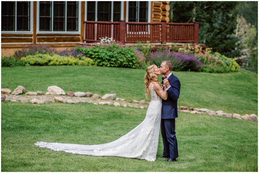 Bride and groom outside beans cabin before wedding