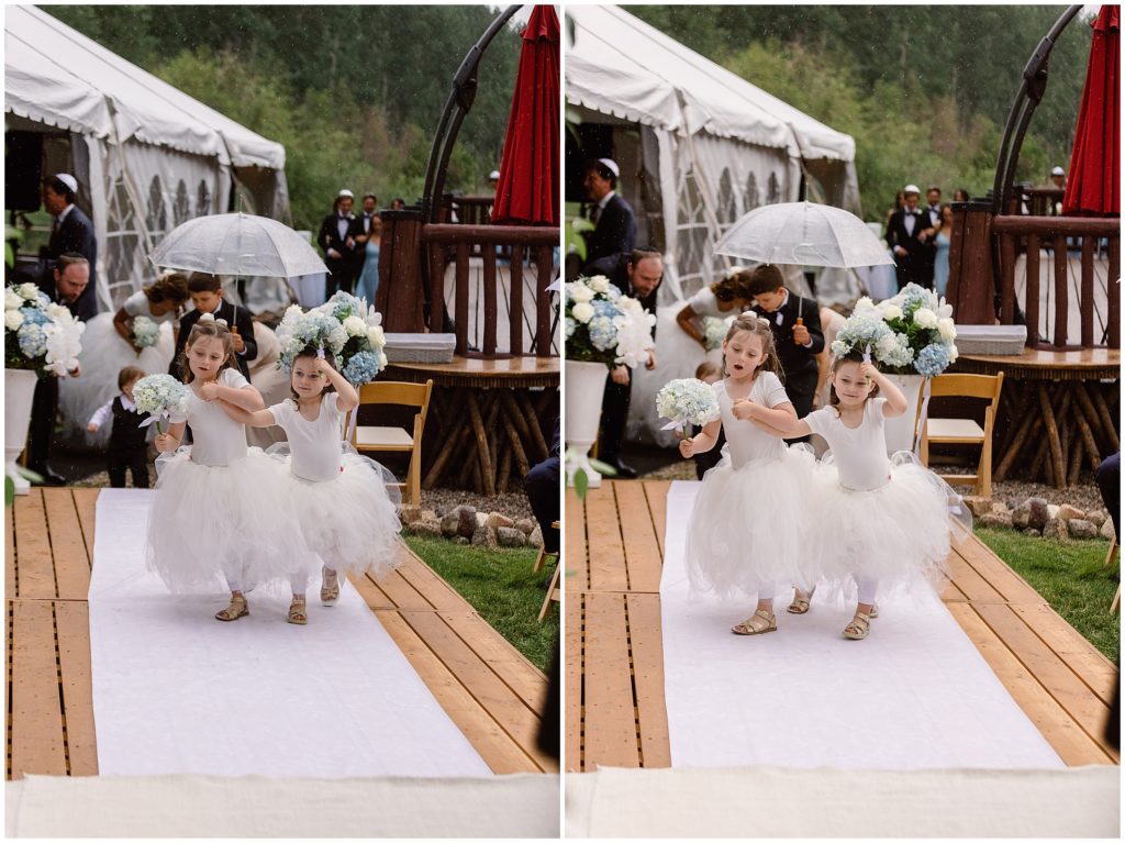 Flower girls walking down the aisle before wedding