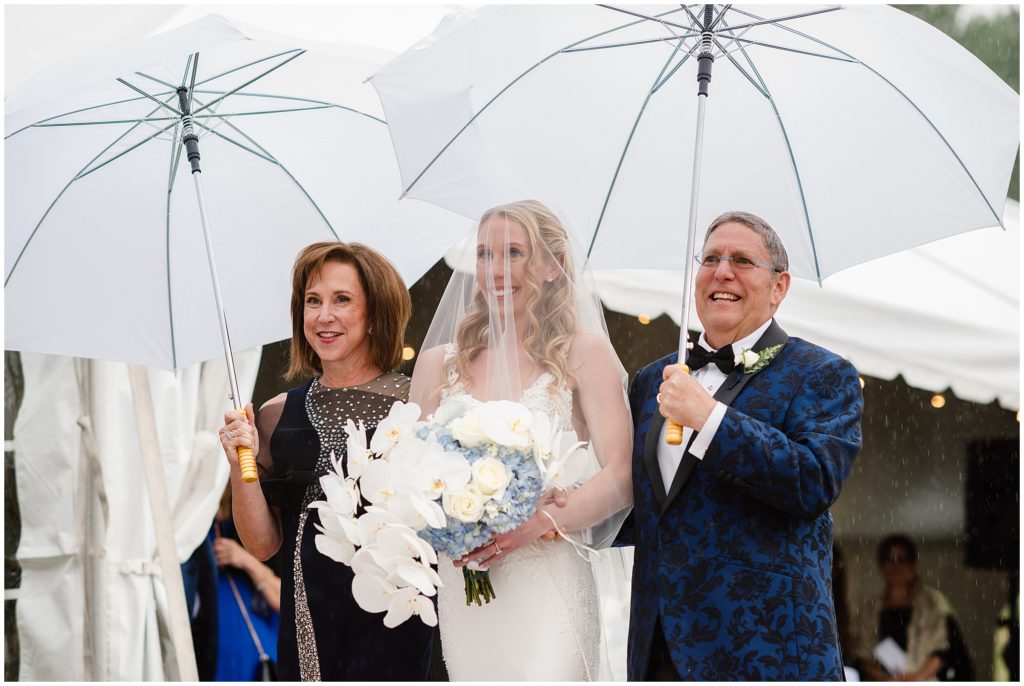 Bride and parents walking down the aisle before wedding