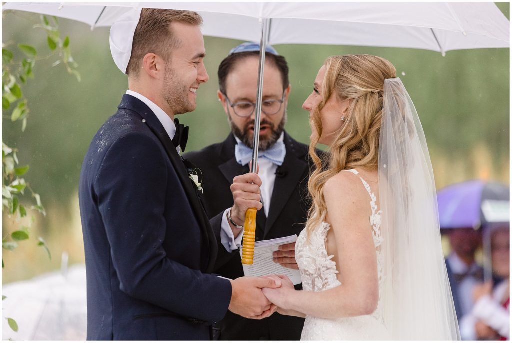 Bride and groom holding hands during ceremony