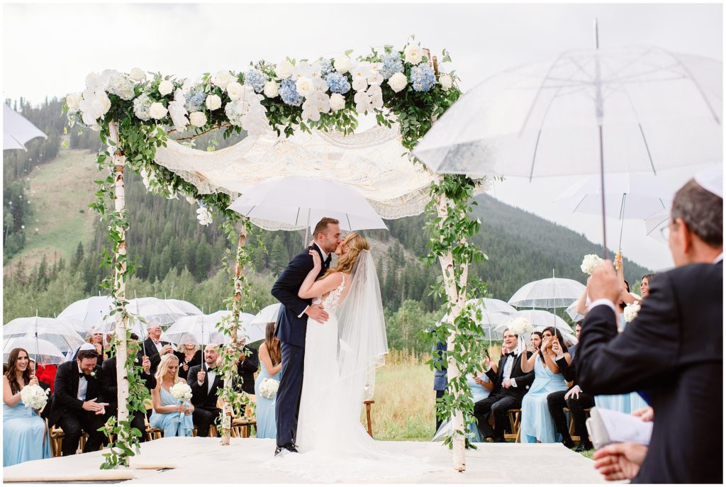 Bride and groom kissing after wedding ceremony