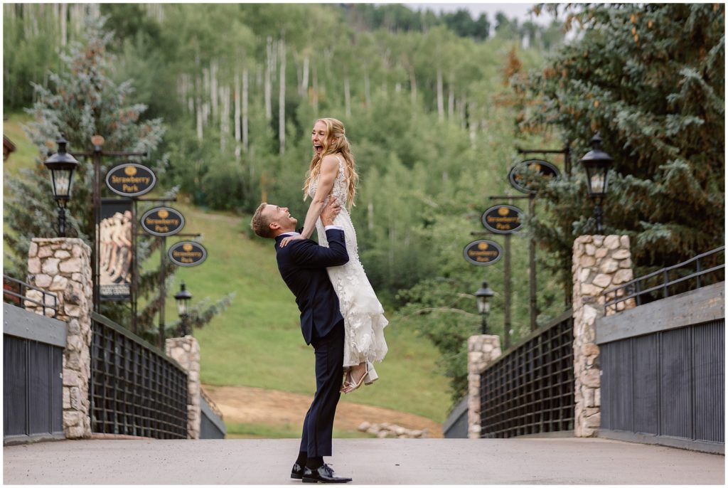 Bride and groom on bridge at Beaver Creek