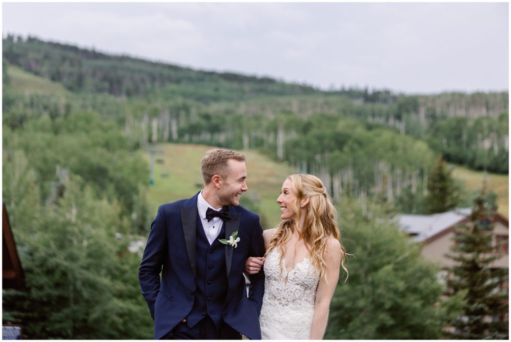 Bride and groom on bridge at Beaver Creek