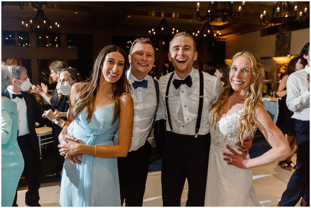 Bride and groom with friends during reception 