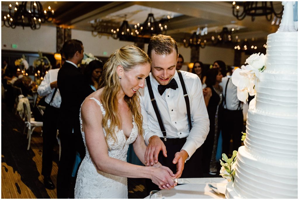 Bride and groom cutting cake designed by 