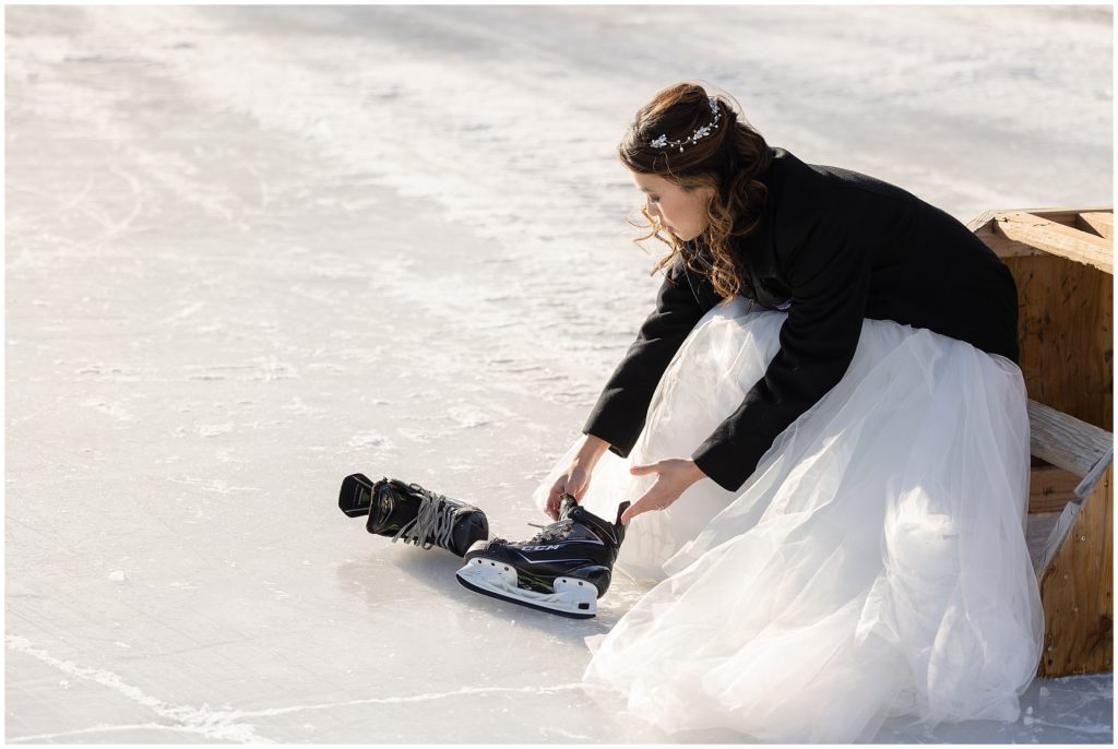Bride putting on ice skates at North Pond Park before elopement