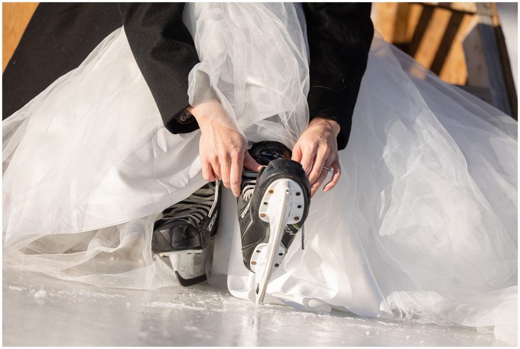 Bride putting on ice skates at North Pond Park before elopement