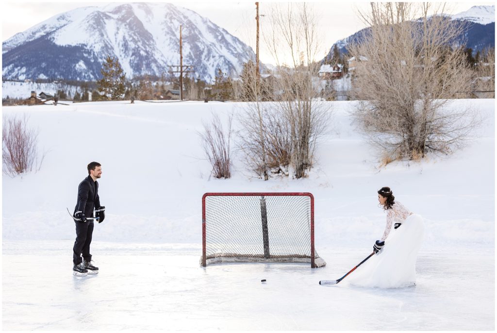 Bride and groom shooting hockey puck at net in North Pond Lake during elopement