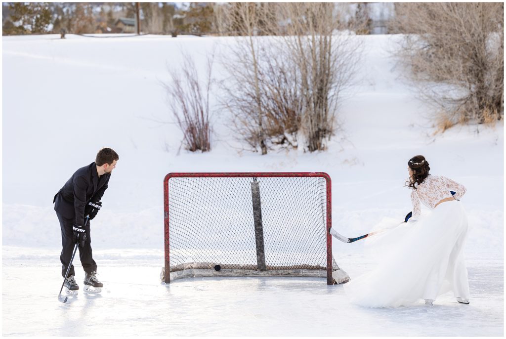 Bride and groom shooting hockey puck at net in North Pond Lake during elopement