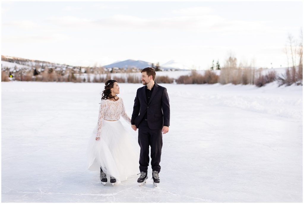 Bride and groom walking North Pond Lake during elopement