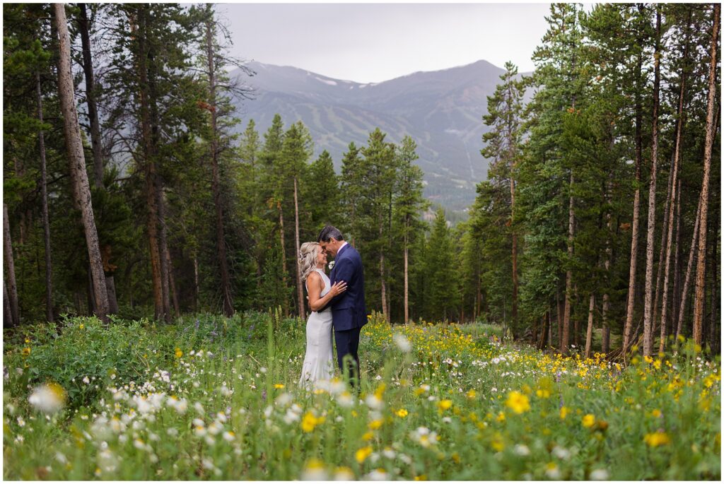 Bride and groom in Breckenridge with wild flowers around them