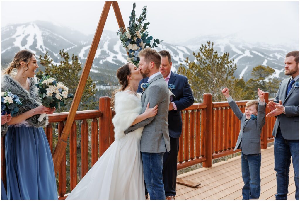 Bride and groom kiss at the end of ceremony at The Lodge at Breckenridge