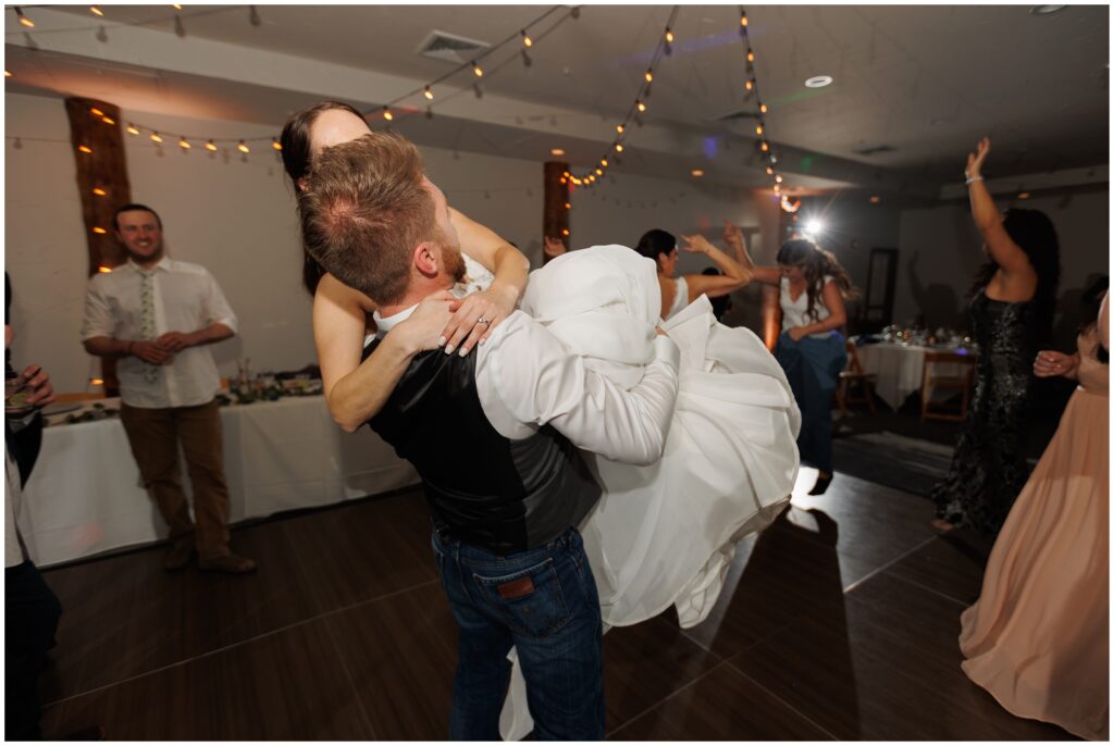 Groom lifting bride during open dancing at The Lodge at Breckenridge
