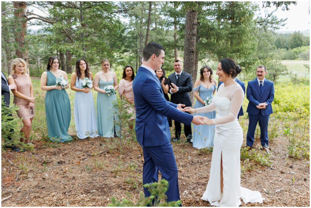 Bride and groom holding hands during first look