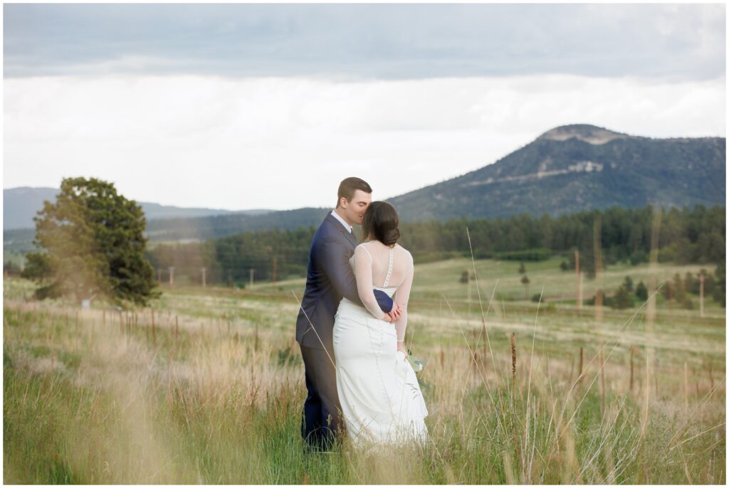 Bride and groom walking alone tall grass in Larkspur Mountains