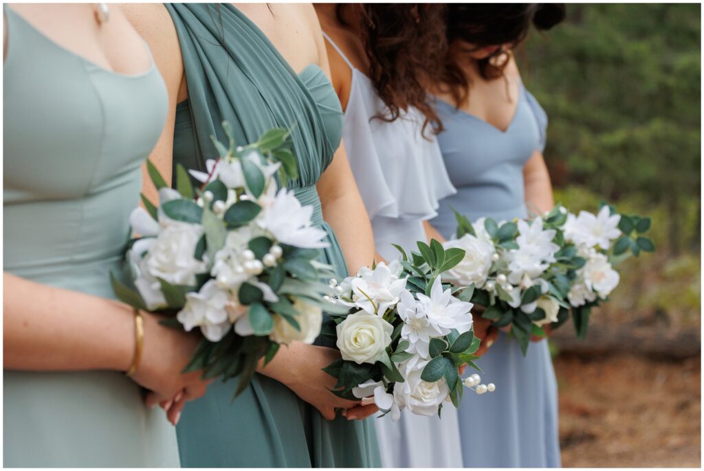 Bridesmaids standing together wearing dresses from Birdy Grey