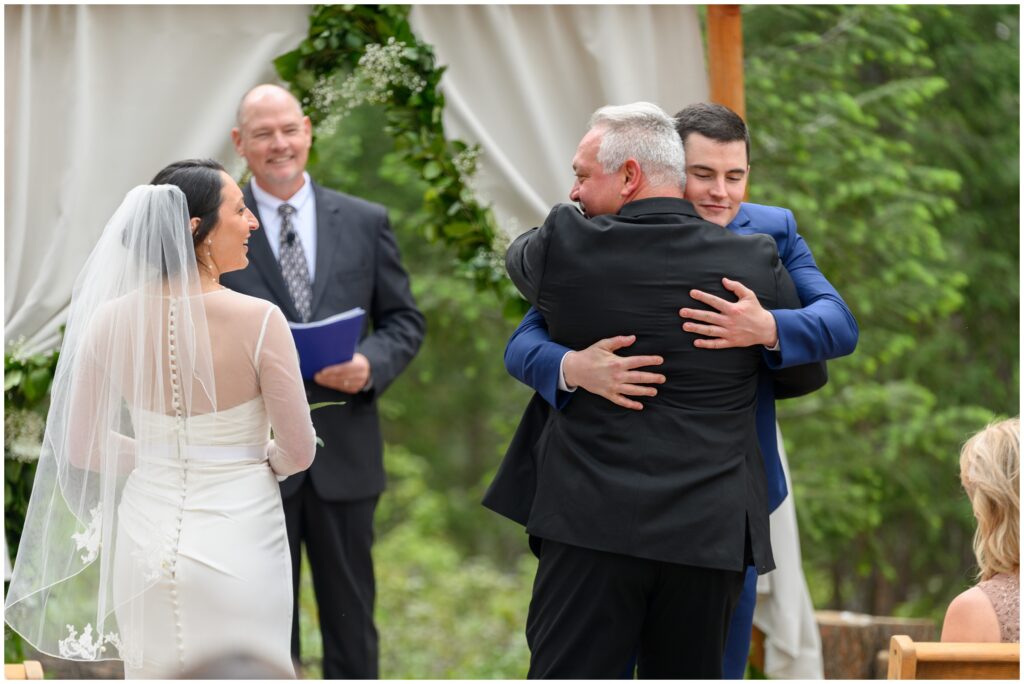 Groom hugging Father of Bride before ceremony