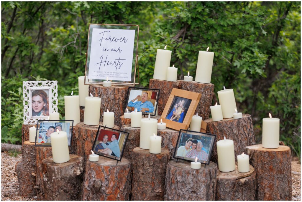 Wood stumps decorated with photos and candles of bride and groom