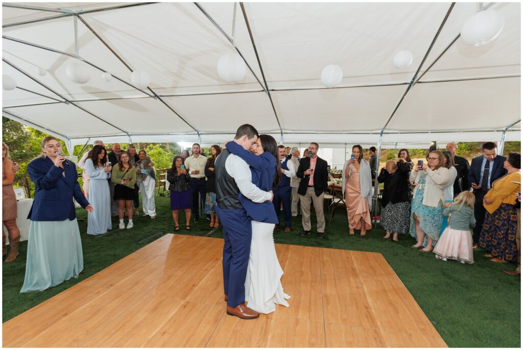 Bride and groom first dance under tent