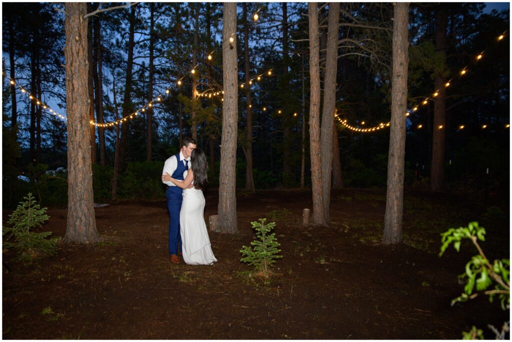 Bride and groom outside at night under string lights in Larkspur mountains