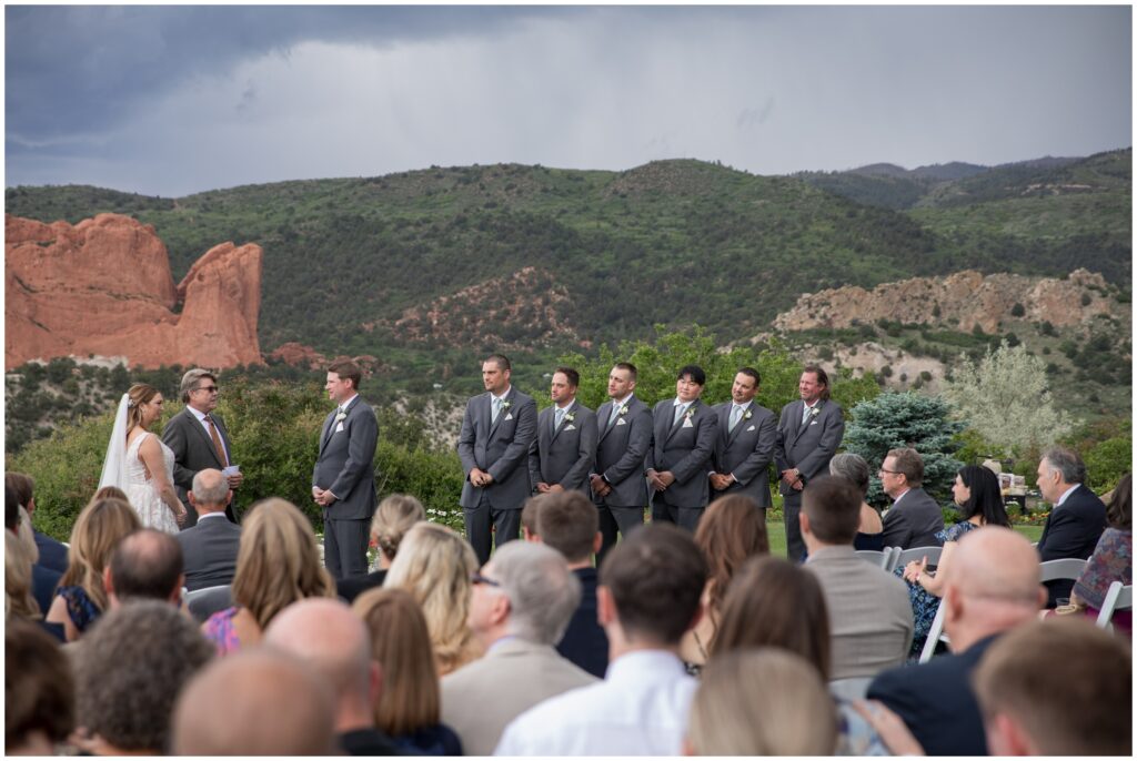 Groomsmen standing with groom during wedding at Garden of the Gods Resort