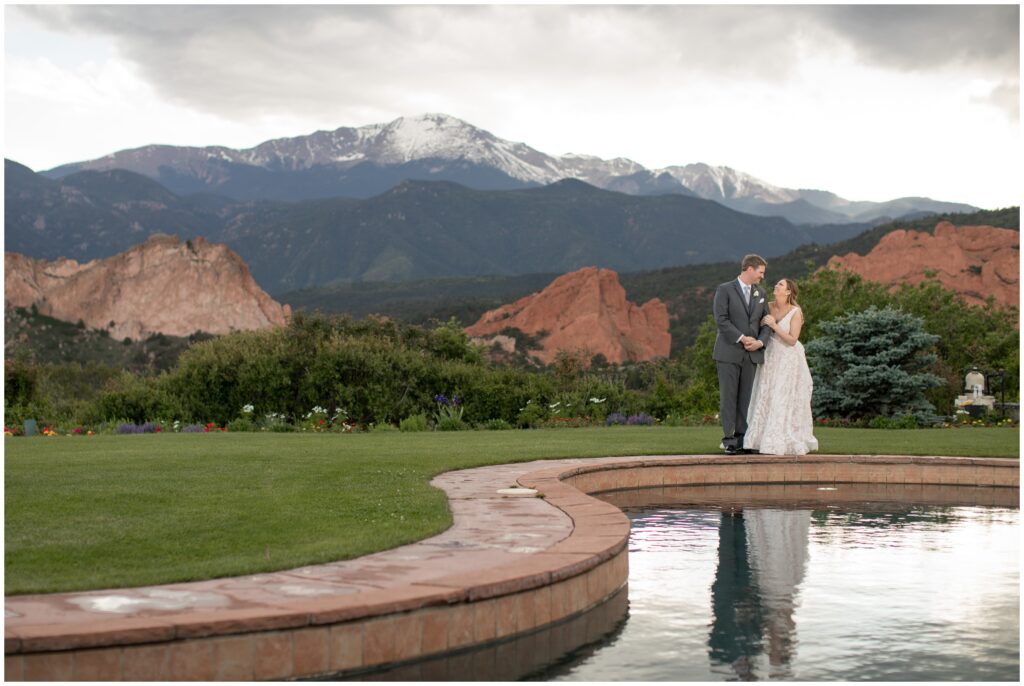 Bride and groom by pond at Garden of the Gods Resort