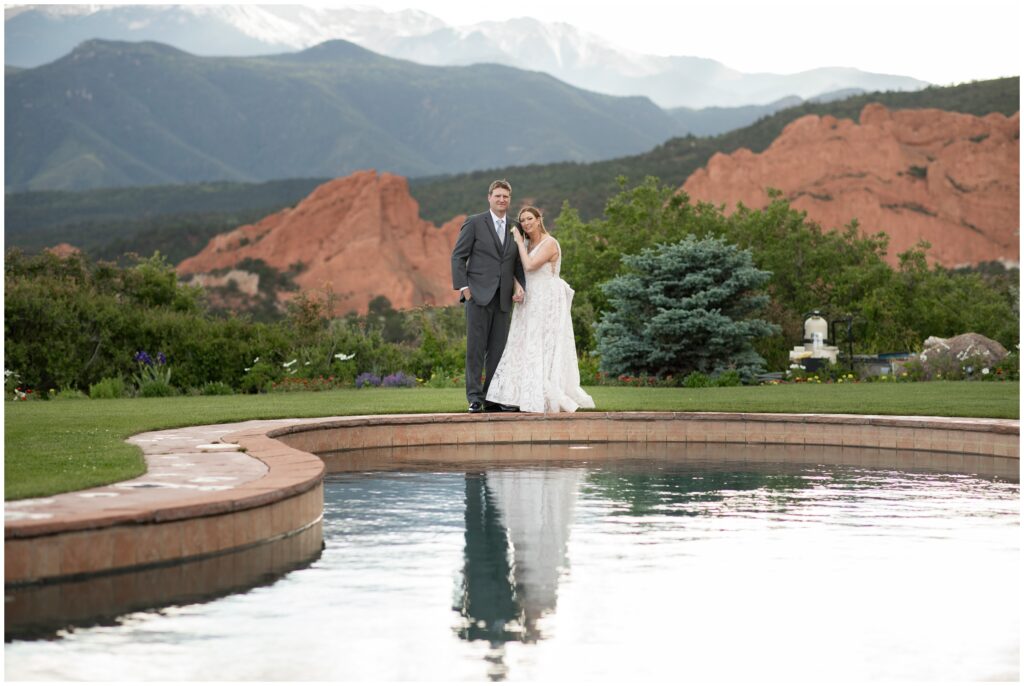 Bride and groom by pond overlooking at Garden of the Gods