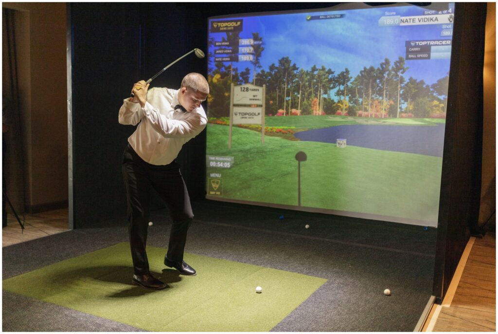 Groomsmen playing golf simulator