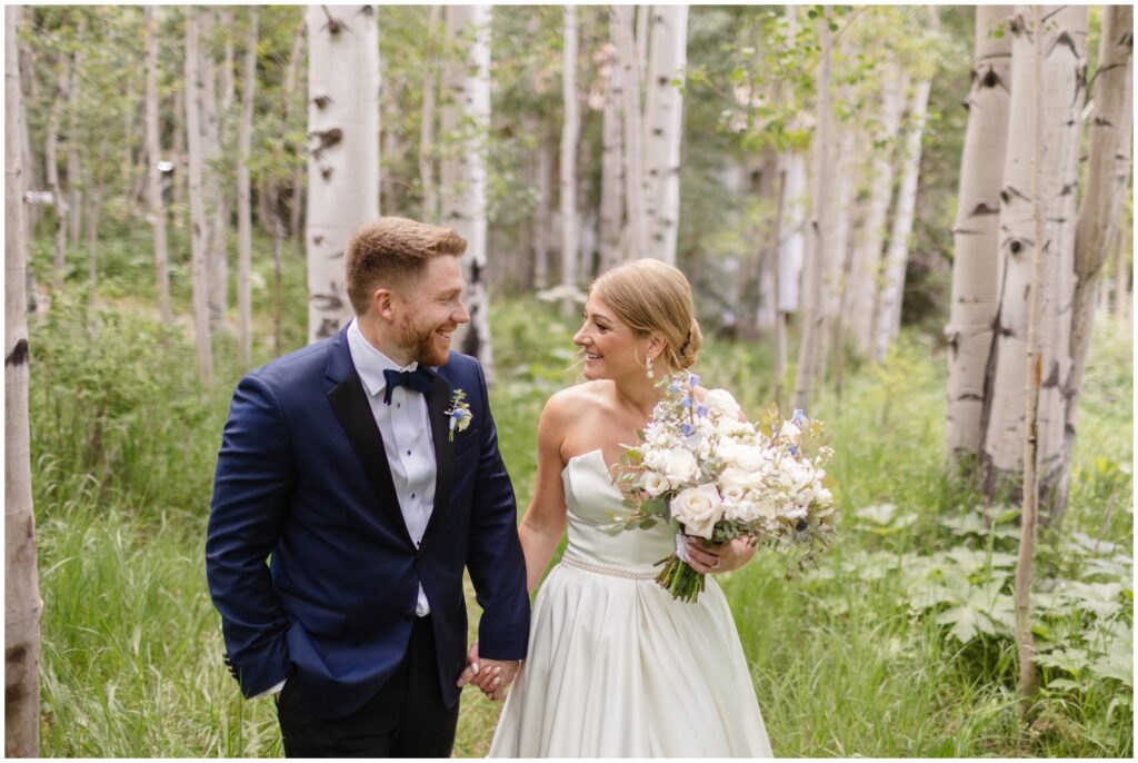 Bride and groom walking in Aspen meadow