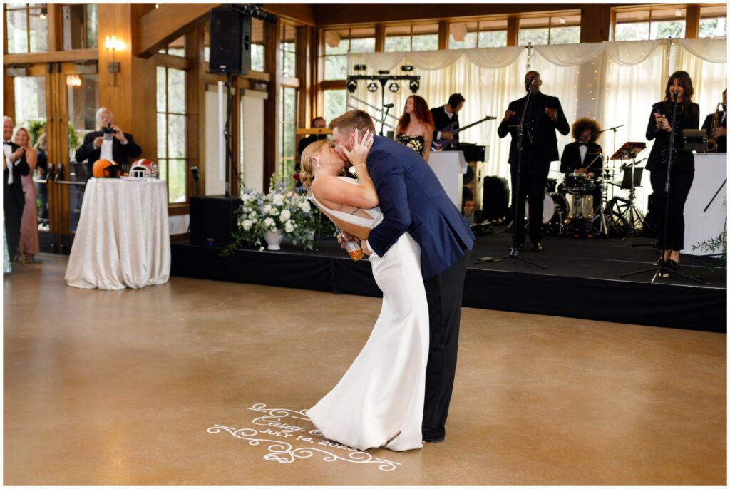 Bride and groom kiss during first dance with The Great Family Reunion Band