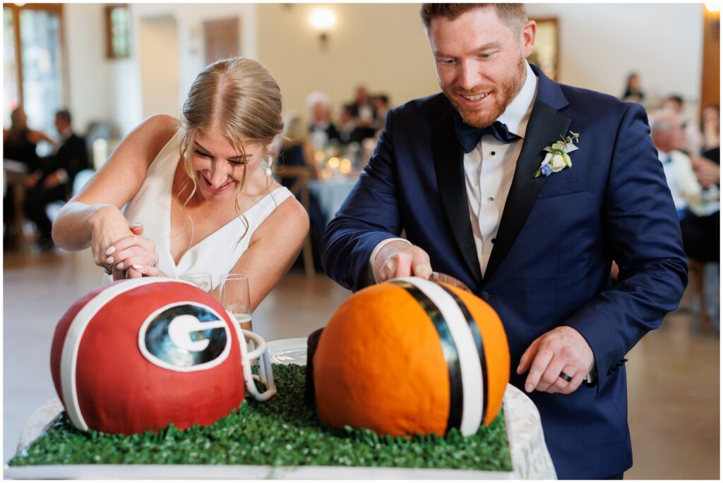 Groom and bride cut Georgia Bulldogs wedding cake designed by Cornerstone Chocolates