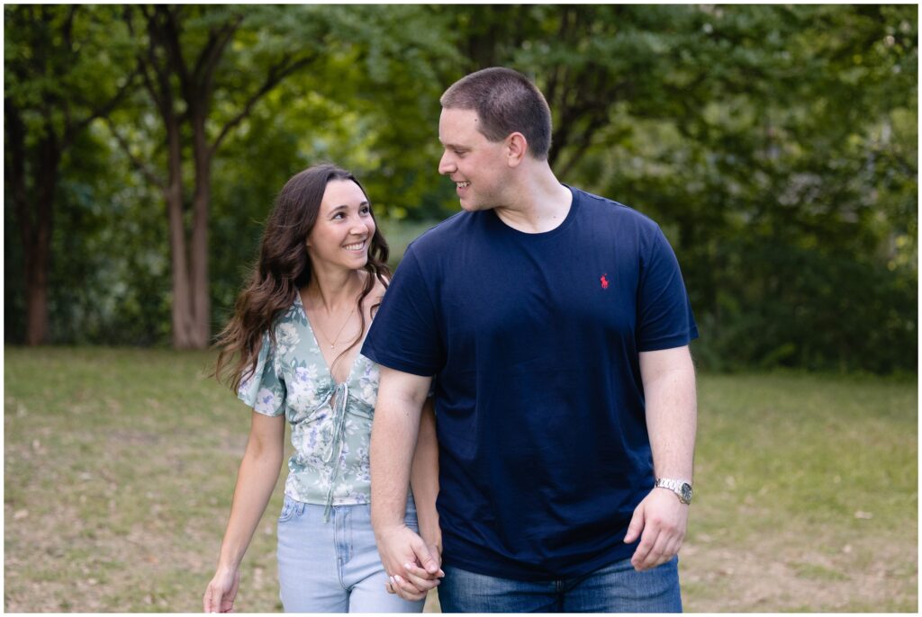 Couple holding hands and walking outside during Austin Engagement session
