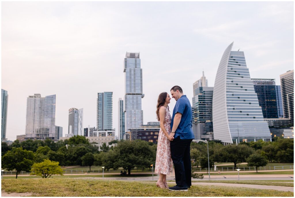 Couple holding hands downtown during engagement session in Austin