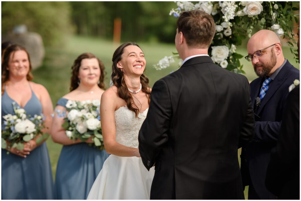 Bride laughing during ceremony at Keystone Ranch