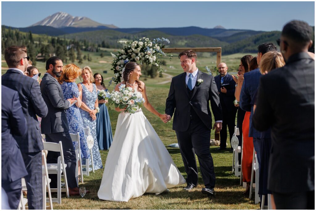 Bride and groom walking down isle at end of ceremony at Keystone Ranch
