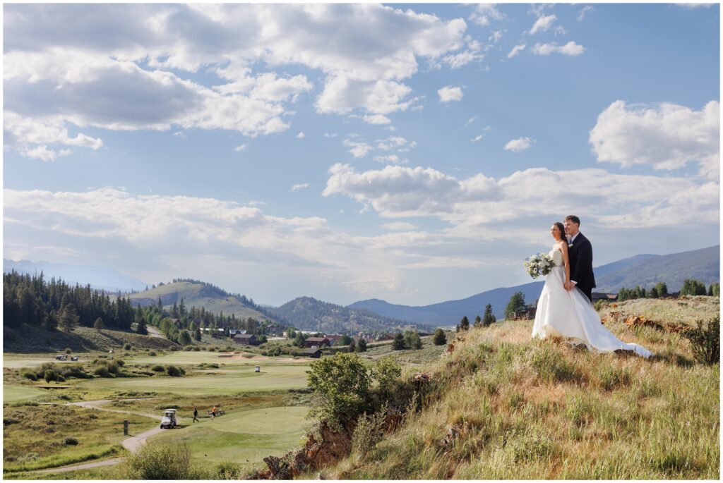 Bride and groom on hill at Keystone Ranch