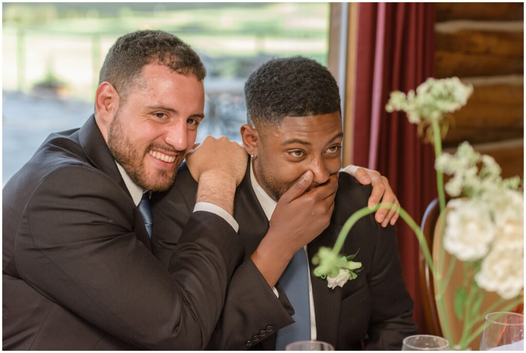 Groomsmen laughing during toasts at Keystone Ranch