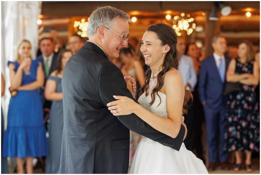 Father daughter laughing during dance in tent at Keystone Ranch
