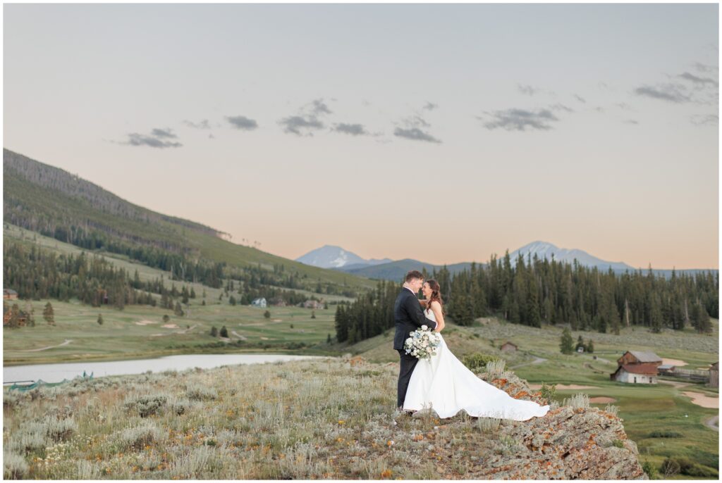 Bride and groom on field hill at Keystone Ranch