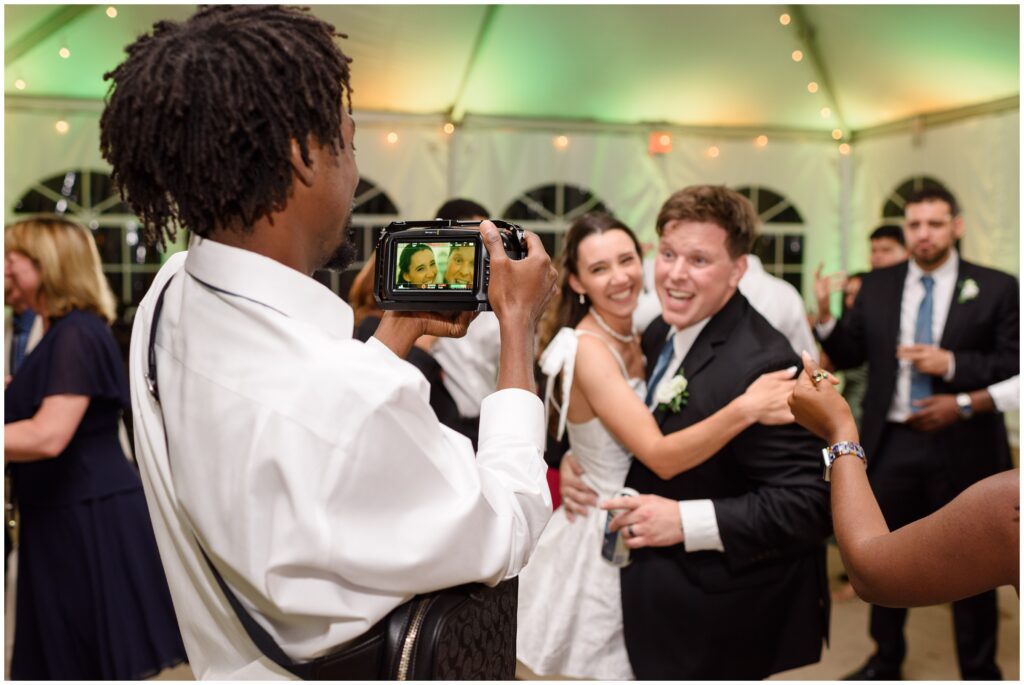 Guests taking photos during open dancing inside tent at Keystone Ranch