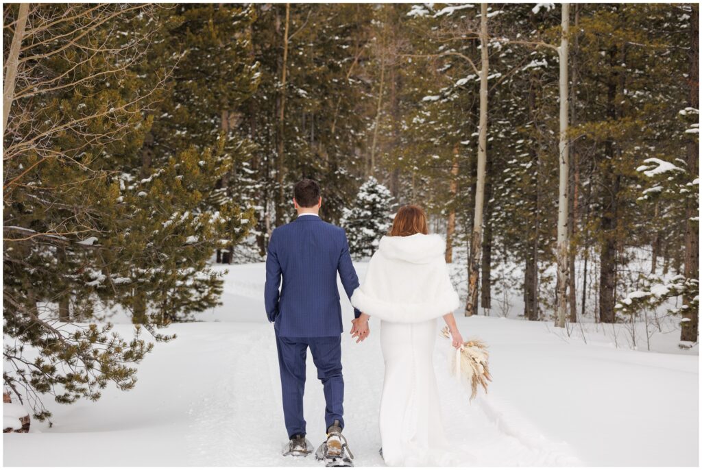 bride and groom walking hill at High Country Lodge Breckenridge