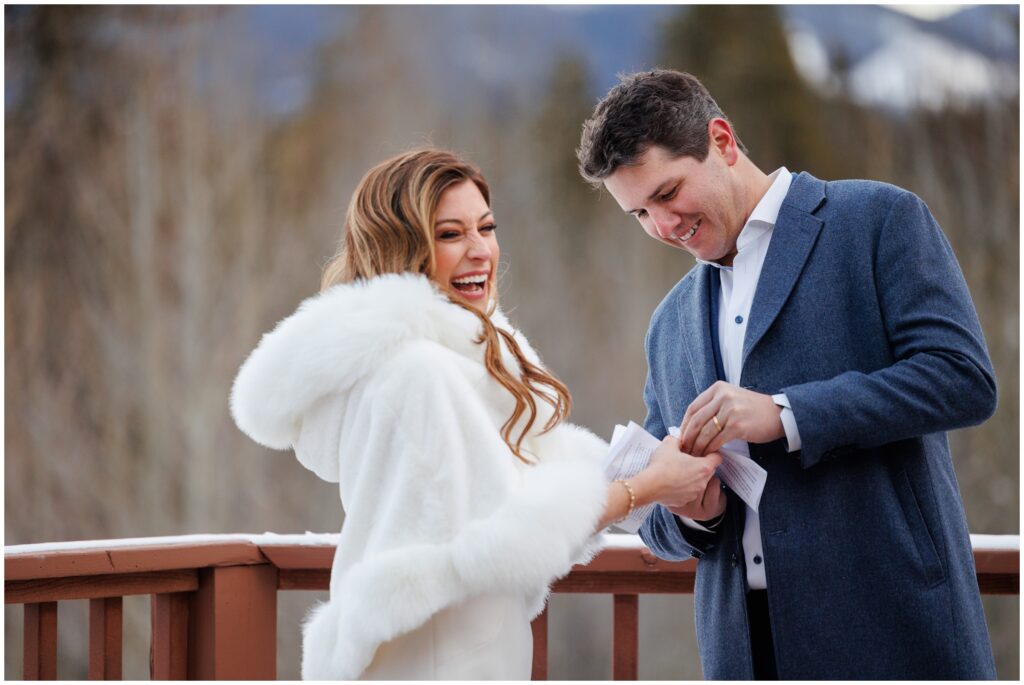 groom putting on ring on bride during ceremony at High Country Lodge Breckenridge