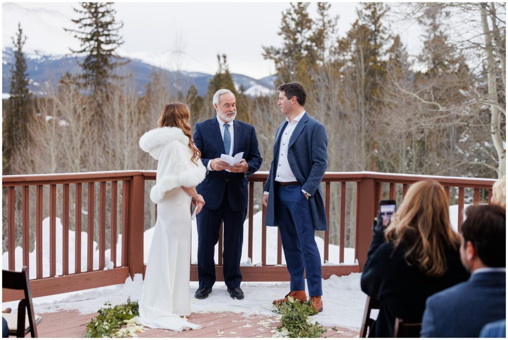 bride and groom listening to officiant during ceremony at High Country Lodge Breckenridge