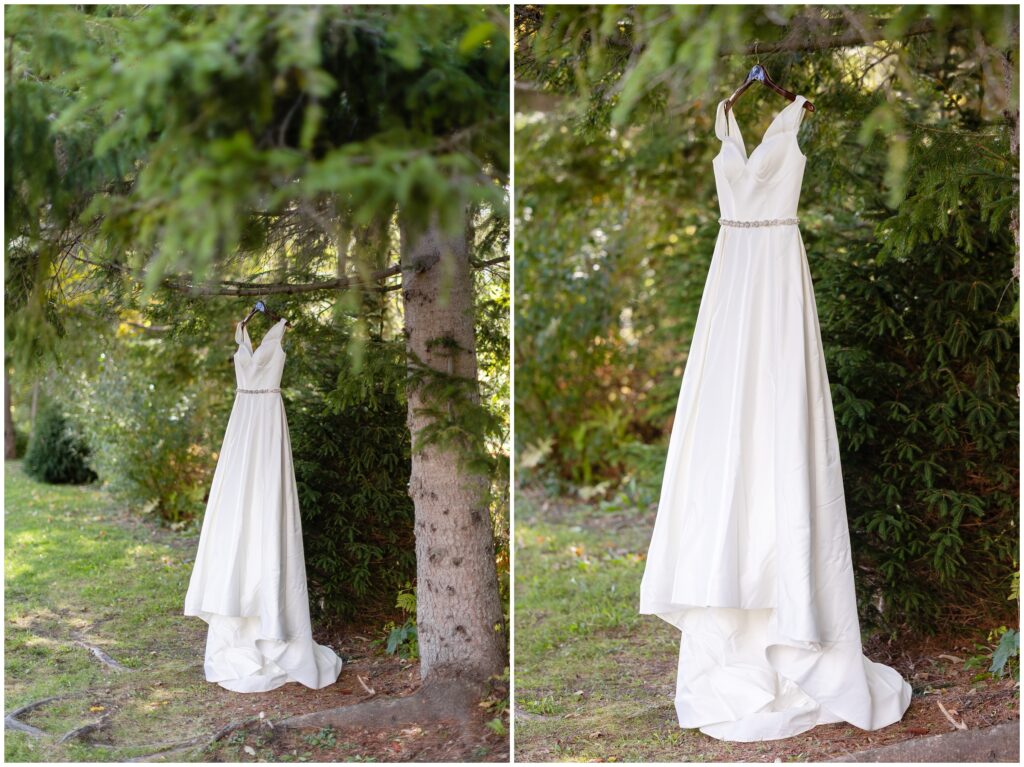 Bride's wedding dress hanging outside on trees