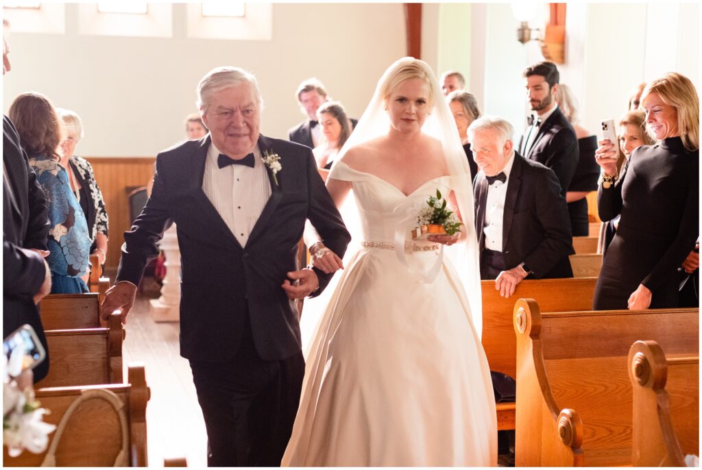 Father and bride walking down isle at Church of Our Savior at Mission Farm in Vermont